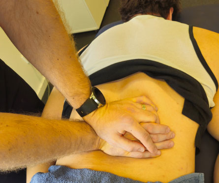 physio pressing lower back